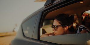 Woman Looks Out Tinted Car Window
